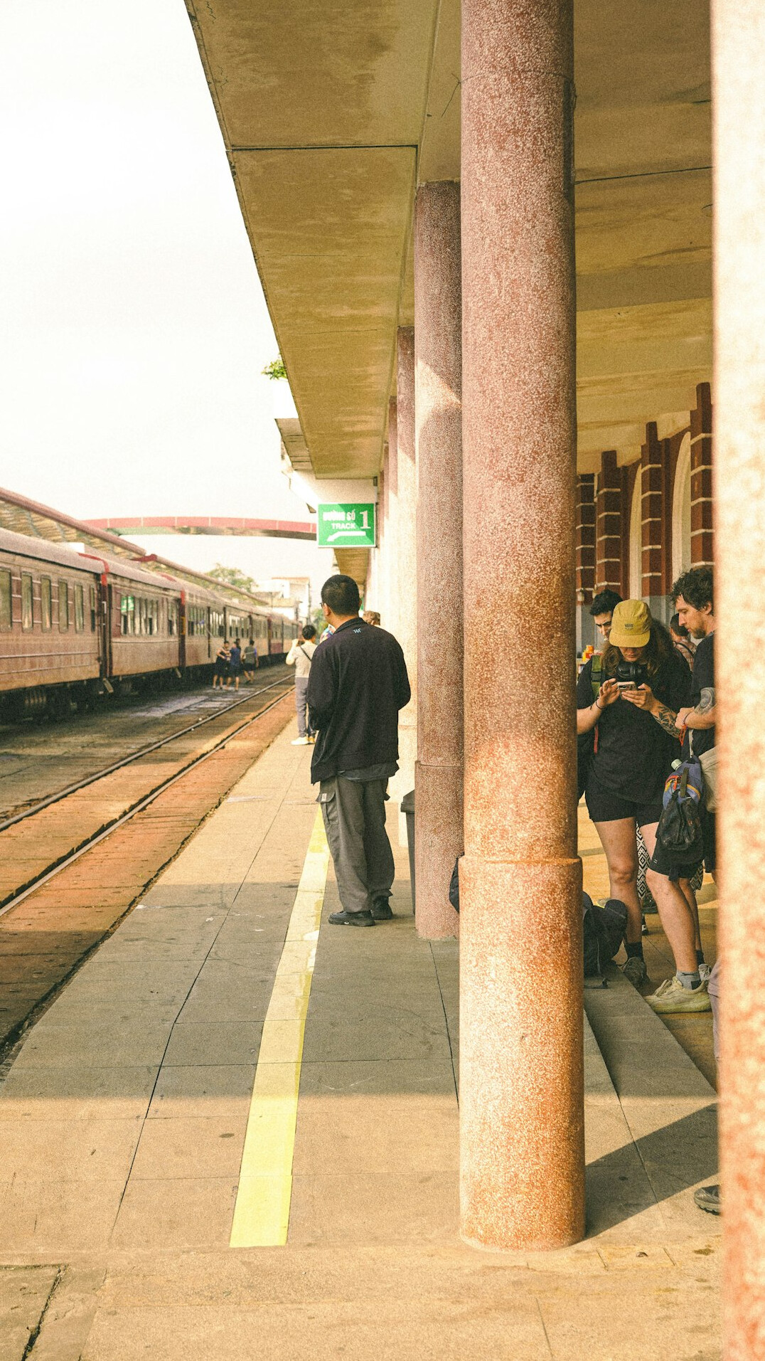 Commuters waiting at a train station platform